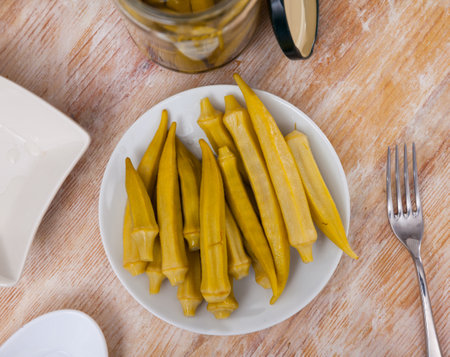 Pickled okra pods on plate, homemade preservesの写真素材