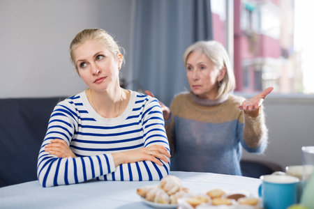 Mature woman scolds her adult daughter