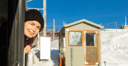 Woman poking her head out of train window during trip