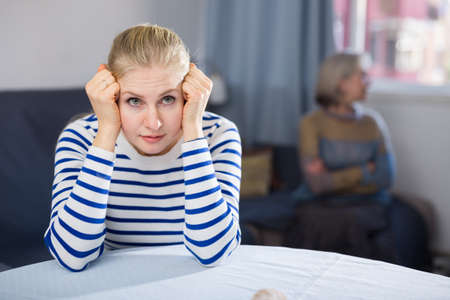 Portrait of an offended adult daughter at her elderly motherの写真素材