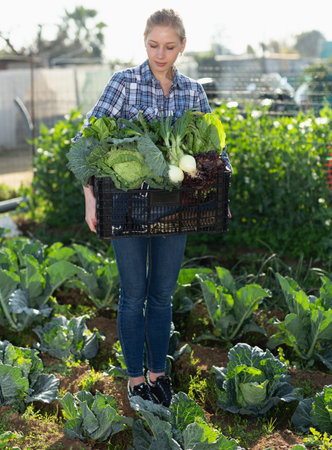 Female gardener standing with harvest