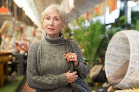 Senior woman shopping in home goods storeの写真素材