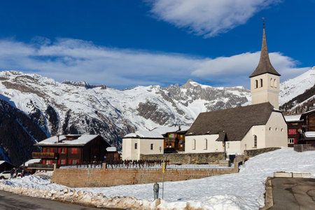 Winter view of Swiss township of Bellwald with parish churchの写真素材