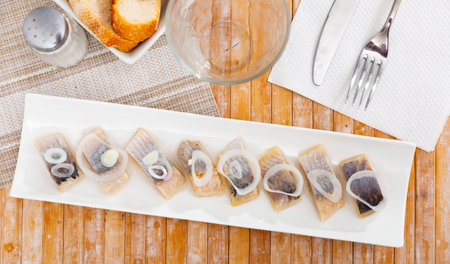 Appetizing herring fillet with onion on top