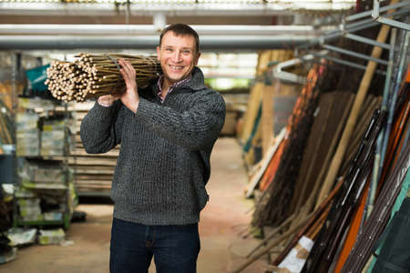 Cheerful man buying decorative fencingの写真素材