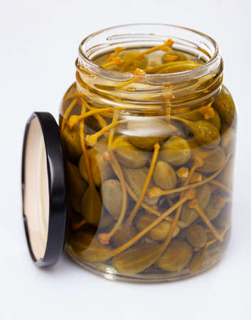 Glass jar with pickled green capersの写真素材
