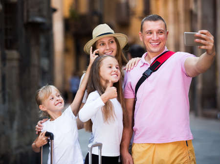 Travelers family taking selfieの写真素材