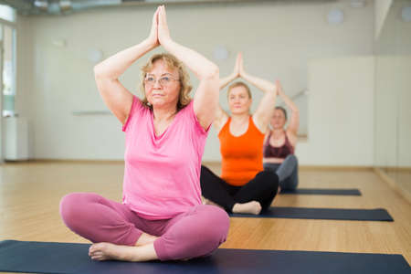 Aged women are sitting in a lotus poseの写真素材