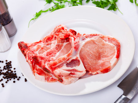 Uncooked pork loins over white backgroundの写真素材