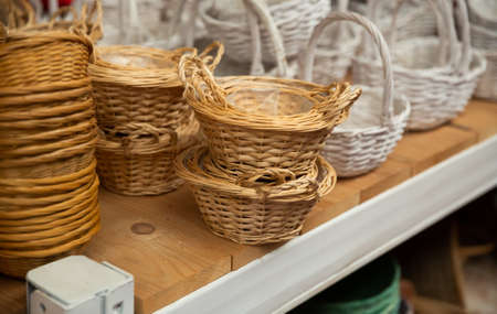 Wicker baskets on shelves in storeの写真素材