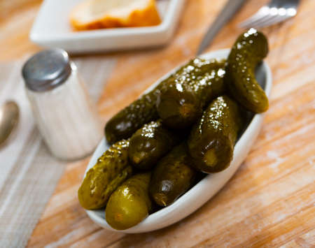 Pickled cucumbers on white plate, homemade preservesの写真素材