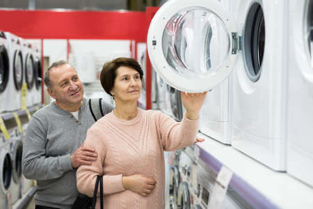 European spouses of mature age choose a washing machineの写真素材