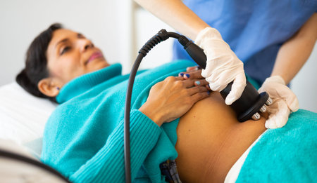Woman receiving radio frequency abdomen lifting procedure