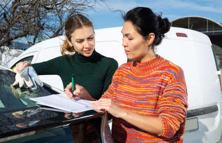 Woman signs the documents for the delivery of the goods to farm fieldの写真素材