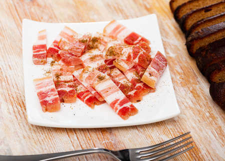 Delicious lard on a plate, cut into piecesの写真素材