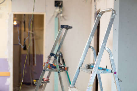 Interior of room being repaired with stepladder and wiresの写真素材