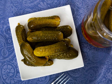 Pickled cucumbers on a ceramic plateの写真素材
