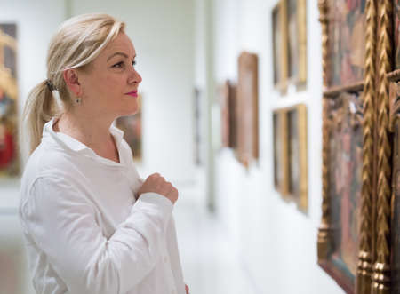 Closeup on mature female visiting museumの写真素材