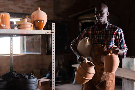 Craftsman carrying ceramic goodsの写真素材