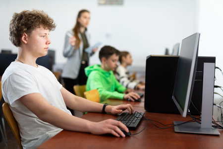 Portrait of guy working at computer in computer class at school