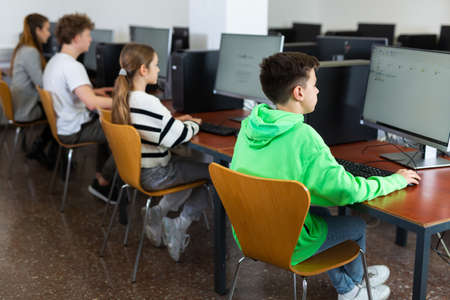 Kids using computers during computer science lessonの写真素材