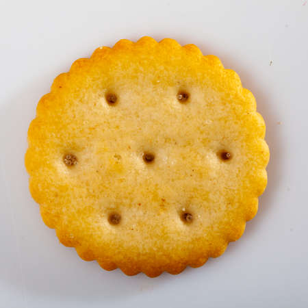 Crispy salted round cracker on white tableの写真素材