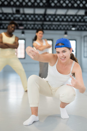 Young beautiful female dancer enjoying dancing break dance