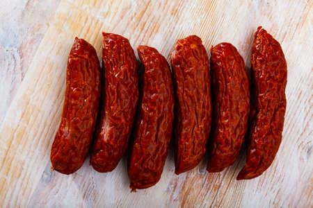 Roasted chezh sausages susena on cutting boardの写真素材