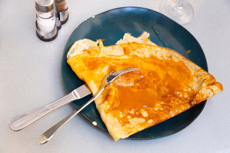 Portion of crepe with salted butter caramel on plateの写真素材
