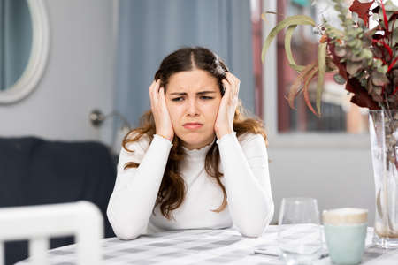 Portrait of stressed young woman at homeの写真素材