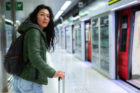 Woman going along just arrived train in subway stationの写真素材