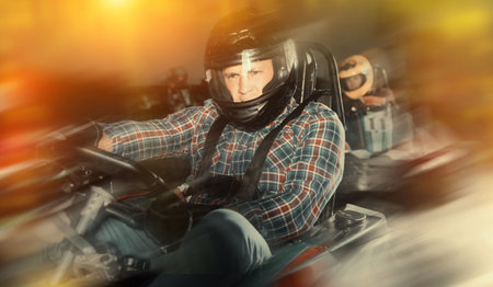 Man and his friends competing on racing carsの写真素材
