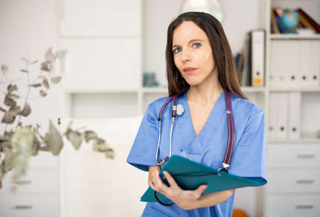 Waist-up portrait of woman medic in officeの写真素材