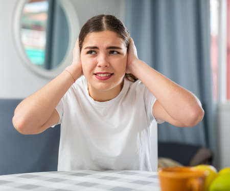 Screaming displeased young woman splashing out emotionsの写真素材