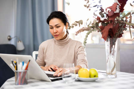 Woman using laptop at homeの写真素材