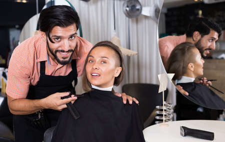 Portrait of young man hairdresser and femaleの写真素材