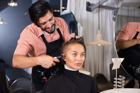 hairdresser working with hair clipperの写真素材