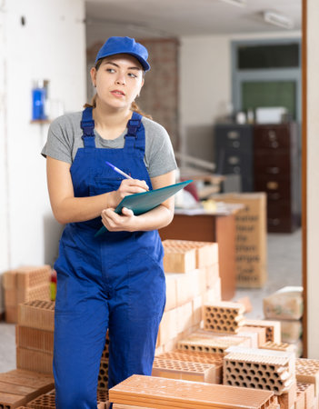 Woman architect taking notes on construction site