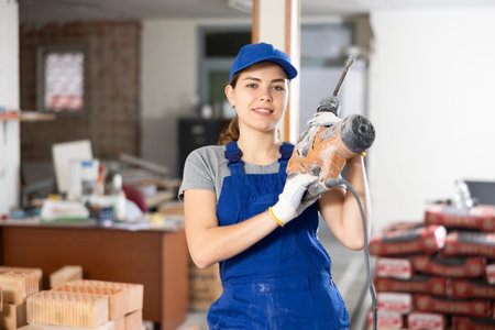 Female worker posing on indoor construction site