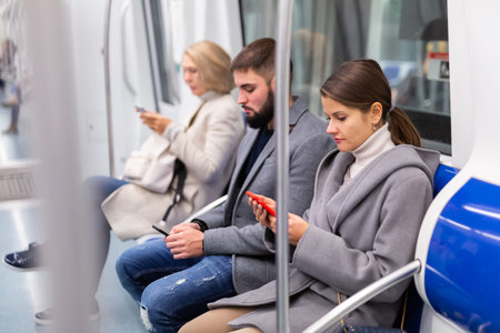 People browsing in smartphone in subway
