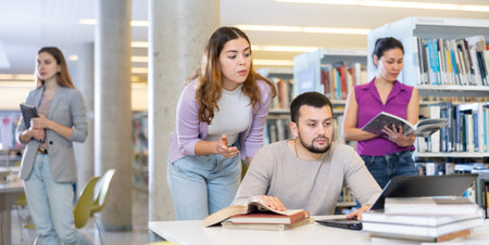 Woman and man studying together at library