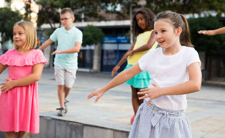 Young boys and girls dancing outdoorsの写真素材