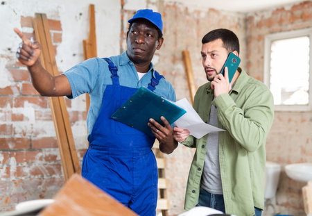 Two men talking on indoor construction site