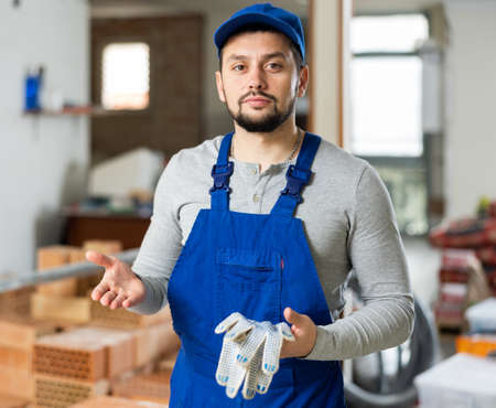 Contractor showing work done in building under constructionの写真素材