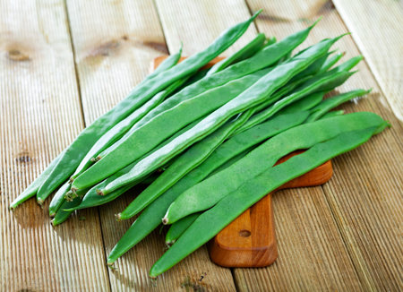 Green beans on wooden table