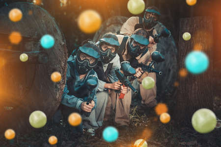 Paintball team aiming outdoorsの写真素材