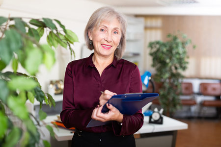 Mature woman meeting visitors at office