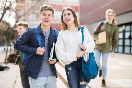 Carefree teen students boy and girl friendly talkingの写真素材