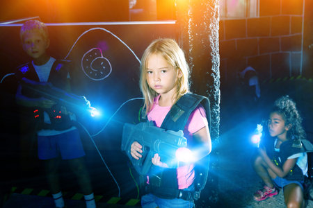 Girl with laser gun playing with friends