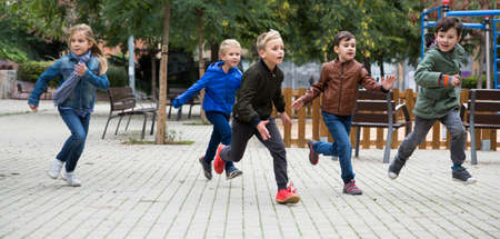 Children running on playgroundの写真素材